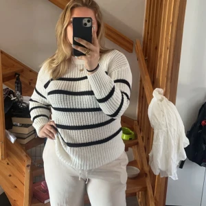 randig stickad tröja💕 - Säljer en snygg vit stickad tröja med svarta ränder. Tröjan har en normal passform och långa ärmar. Väldigt skön och passar till sommaren💕