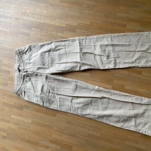 Beiga linnebyxor med snörning - Snygga och luftiga beiga linnebyxor från lager 157 Perfekta för varma dagar, med avslappnad passform och raka ben. Lätta att matcha med både t-shirt och skjorta.