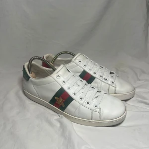 Gucci ace bee - Gucci ace bee | Nypris: 9000kr | Storlek: 42-43, innermåttet är 28cm |Skick: Bra (slitage kan ses i bilderna) | Medföljer: box, 2 dustbags, 2 kort och en antisvett påse | extremt snygga och är extremt eftertraktade nu till sommaren! Passar både fest och vardag! Hör av dig vid minsta lilla fråga🤩