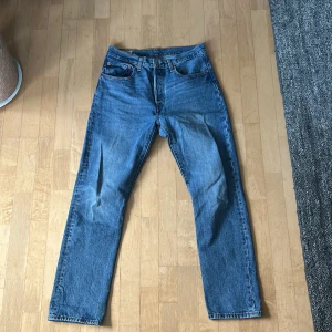 Levis 501 blå jeans - Klassiska blå Levis 501 jeans med raka ben och knappgylf. Storlek W32x32L köpt från second hand men ser nästan helt nya ut.