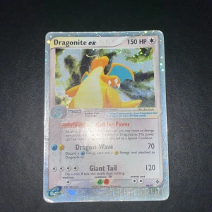 Dragonite ex 90/97 Pokémonkort - Säljer ett Dragonite ex Pokémonkort med holografisk yta. Kortet har 150 HP och visar Dragonite i en dynamisk pose med blå vingar och gul kropp. Kortet har attacker som Dragon Wave och Giant Tail. Perfekt för samlare eller Pokémonfans. - Skriv till mig vid Intresse