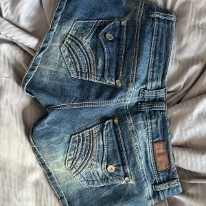 Lågmidjade jeans shorts  - Lågmidjade jeansshorts, liknande true religon. 