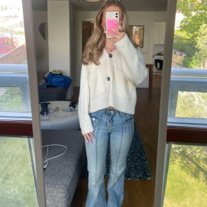 Ljusblå bootcut jeans utan bakfickor  - Säljer ett par ljusblå jeans med bootcut passform och markerade pressveck framtill. Byxorna har låg midja, byxorna har inga bakfickor och är i ett väldigt mjukt stretchigt material. 