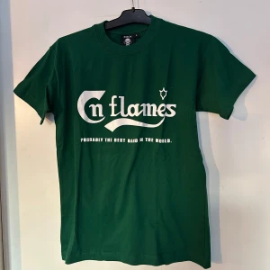 Grön t-shirt med In Flames-tryck - Snygg grön t-shirt från Rock Off med tryck av bandet In Flames. Texten 'Probably the best band in the world' finns under loggan. Perfekt för fans av bandet!
