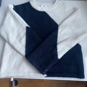 Blå och vit tröja med geometriskt mönster - Snygg och stilren tröja i marinblått och vitt med ett geometriskt mönster. Tröjan har långa ärmar och en rund halsringning. Perfekt för en trendig look. Och för kalla vinterdagar