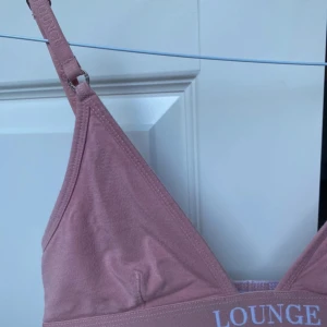 Rosa topp från Lounge - Säljer en superfin rosa topp från Lounge. Den är i en mjuk och bekväm bomullsmix med justerbara axelband. 