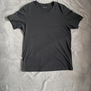 Svart t-shirt från Boss - Säljer en svart hugo boss t-shirt, 9/10 skick, inga deffekter.Perfekt för både vardag och fest! Kan mötas i hela skåne! Fraktar samma dag. Pris är inte huggdet i sten.