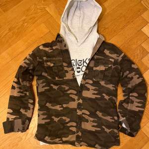 En camoflage overshirt ifrån Jack & Jones i grön/brun färg, det finns fåtal exemplar utav den här overshirten vilket gör den sjukt unik, storlek M (sitter som M eller stor S), inga defekter eller liknande, skriv vid frågor!