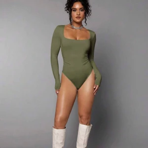 Nytt! Olivgrön långärmad bodysuit från Shein - storlek L - Snygg olivgrön bodysuit från Shein med långa ärmar och fyrkantig halsringning. Storlek L. Säljs den för den passar ej mig. Bodyn är helt nytt och oanvänd 