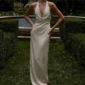 Champagnefärgad långklänning/balkläning - Elegant champagnefärgad långklänning med  v-ringning och öppen rygg. Super fin satin klänning till balen eller speciella tillfälle, helt ny med prislappen kvar💕💕