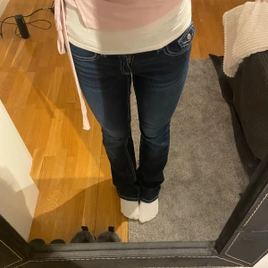 Mörkblå low waist bootcut jeans - Snygga mörkblå lågmidjade bootcut jeans med kontrasterande vita sömmar och bakfickor med knappar💙 Använda 1 gång, alltså som nya i skick!⭐️ Köpta för 359kr