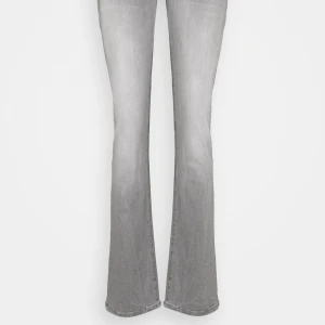 Grå bootcut jeans - Snygga grå bootcut jeans med klassisk femficksdesign och knappgylf. Perfekta för en avslappnad stil med en touch av retro. De har en bekväm passform och är tillverkade i ett slitstarkt material.