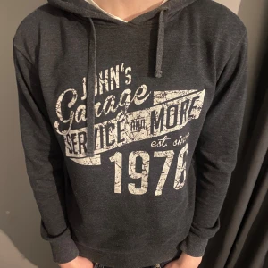 Mörkgrå hoodie med tryck - Säljer en fet mörkgrå hoodie från smog | Storlek: S | Hör av er för frågor 😁                                                                             Längd på modellen: 183
