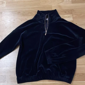 Marinblå tjocktröja  - Säljer en marinblå tjocktröja med sammetskänsla (material polyester) från Lindex. Storlek 158/164 (12-14år). Den har guldfärgad dragkedja upptill vilket man kan se på bilden. 