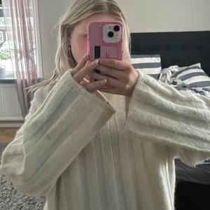 Vit stickad tröja - Mysig vit stickad tröja med ribbade detaljer och långa ärmar. Stolek S
