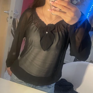 Blus - Väldigt fin genomskinlig svart plus med en lite detalj på framsidan