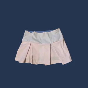 Rosa kortkjol med blå insida - Söt rosa kortkjol. Kjolen har en knappdetalj i midjan och är blå på insidan(:  Har sytt den själv. Storlek S /XS