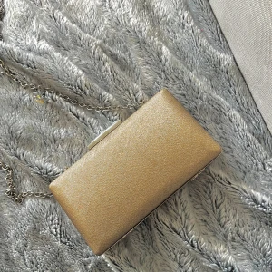 Guld väska  - Jättefin väska i guld, köpte för ett tag sen men har inte kommit till användning Så fin till fest/nyår/liknande 