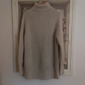 Beige ribbad polotröja från Cubus - Säljer en stilren beige polotröja från märket Cubus i storlek XS. Det är en lång tröja som är ribbad och inte nopprig. 