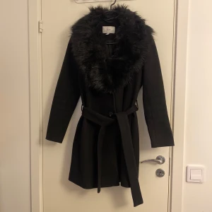 Pälskappa  - Köptes förra året och är använd fåtal gånger. Fuskpälsen går att ta av o sätta dit med små knappar. Två av knapparna som sätter fast pälsen har trådar som ser lite tråkiga ut men alla funkar. Lite nopprigt på insidan av ärmarna.