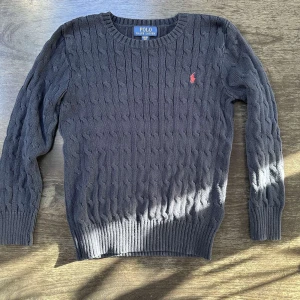 Ralph Lauren kabelstickad - Marinblå kabelstickad tröja från Ralph Lauren. Använd men i bra skick.