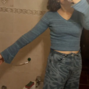 Blå stickad tröja från Subdued - Säljer en mysig blå stickad och kroppad tröja från Subdued med utsvängda armar. Tröjan har en v-ringad hals och långa ärmar med ribbade muddar. Perfekt för kyligare dagar. Passar bra till jeans eller kjol för en avslappnad look.