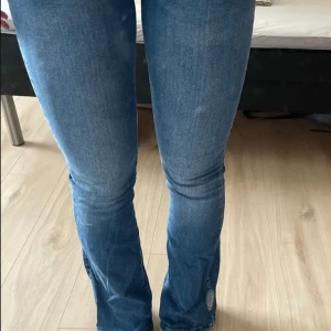 Blå bootcut jeans - Säljer ett par snygga blå bootcut jeans. De är i bra skick och har en klassisk blå färg som passar till allt. Passar storlek S-M (28/32). 