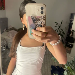 Vit ärmlös linnetopp från SHEIN - Säljer en stilren vit ärmlös linnetopp. Perfekt för varma dagar och enkel att matcha med olika outfits. Den har en knytdetalj i sidan 💗