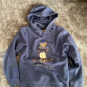 Blå Polo Ralph Lauren Bear hoodie  - Snygg ljus blå Polo Bear Hoodie! Storlek L i barn passar dig runt 165-170! Kom privat vid funderingar😊