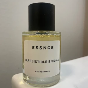 Irresistible Enigma Eau de Parfum från Essnce - Irresistible Enigma från Essnce, en perfym med lockande doft. Flaskan är elegant med en enkel design och svart kork. I princip oanvänd! 