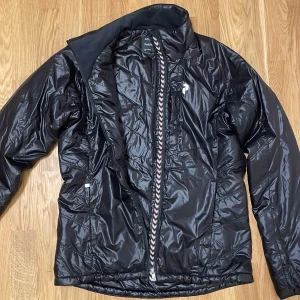 PeakPreformance glansig vinterjacka - Glansig Peak Preformance jacka. Är den ända ägaren har bara använts ett fåtal gånger. Orginalpris ca 3000 kr, säljs pga att jag inte har användning för den längre. Style: SUPR PL J. Det är bara att skriva om du har frågor.