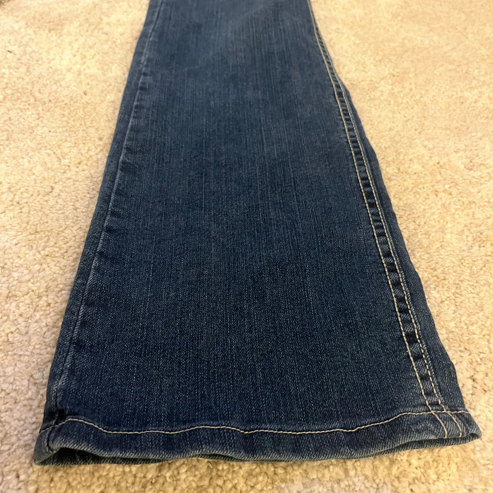 Utsvängda lågmidjade jeans från Wrangler med rosa detaljer i storlek M/38💞Fickorna har broderade detaljer. Köparen står för frakten. Skriv för frågor, mått osv❣️. Jeans & Byxor.