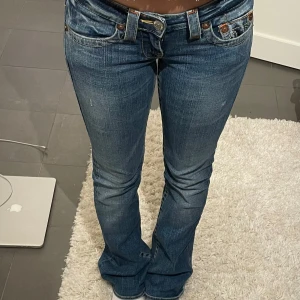 Lågmidjade bootcut true religion jeans - Jättefina lågmidjade bootcut true religion jeans som är helt oanvända och med prislapp kvar. Samma modell som första bilden bara lite mörkare och en annan storlek. (Säljer då de är för små)