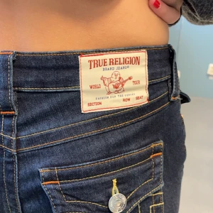 Mörkblå jeans från True Religion - Säljer ett par snygga mörkblå jeans från True Religion. De är midwaist/lågmidjade. Storlek 25, använda 1 gång så det är nyskick! 