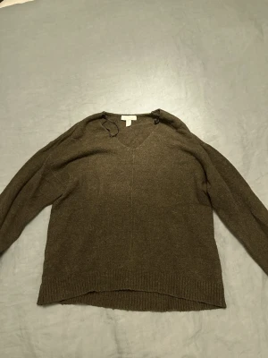 Olivgrön stickad tröja med v-ringning - Tunn stickad olivgrön tröja.
