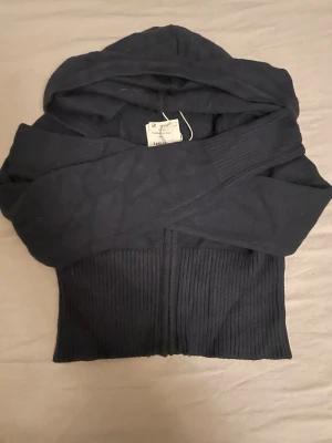 Marin blå tröja från Gina tricot - Marin blå zip tröja i tunt stickat material. Tröjan har en luva och dragkedja framtill. Tröjan är helt ny med prislapp kvar. Säljer då jag köpte i fel storlek!💗