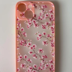 Blommigt skal till iPhone 14 - Mobilskal med rosa blommönster, designat för iPhone 14. Skalet är i nytt skick, aldrig använd och utan synligt slitage.