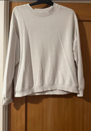 Vit sweatshirt från Monki - En stilren vit sweatshirt från Monki i storlek S. Tröjan har rund hals, långa ärmar och en relaxed passform. Tillverkad i mjuk bomull som är skön mot huden. Perfekt för chill dagar och enkel att matcha med jeans eller leggings.