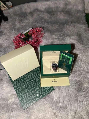 Rolle GMT-Master II Pepsi stål - Rolle GMT-Master II med klassisk Pepsi-ram i rött och blått, svart urtavla och jubilee-länk i stål. Klockan har tydliga index, datumfönster och levereras i originalbox med certifikat. En ikonisk modell med sportig känsla och exklusiv look.