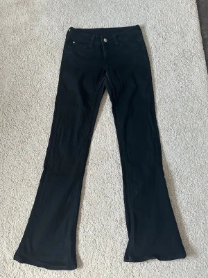 Svarta bootcut jeans från Cheap Monday, 27/32 - Säljer ett par skitsnygga svarta jeans från Cheap Monday. Byxorna har en rosa etikett med logga bak i midjan. Jeansen är i mycket bra skick och inte speciellt använda.