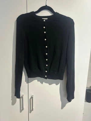 Svart kofta med pärlknappar - Säljer en svart kofta med långa ärmar och snygga pärlknappar framtill. Jätte snygg i storlek xs💗