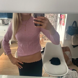 Ljusrosa stickad tröja - Säljer en ljusrosa stickad tröja med rund hals och långa ärmar. Tröjan har en slim passform och är mjuk och skön mot huden, perfekt för att ge en färgklick till din outfit. Passar dig som gillar enkla och stilrena plagg.