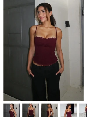 Vinröd korsett-topp med spetskant - Helt oanvänd med lappen kvar. Den var snäppet förfluten för mig men annars super fin! Trendig vinröd korsett-topp med smala axelband och dekorativ spetskant upptill. 