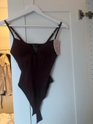 Populär hm body - Säljer den populära, slutsålda hm bodyn i vinrött och storlek xs. Aldrig använd med prislappen kvar❣️