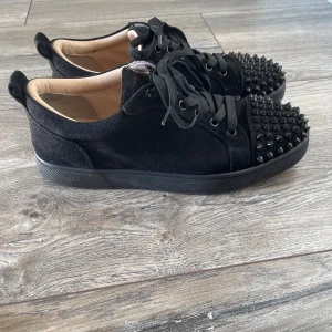 Louboutin - Säljer ett par svarta sneakers från Christian Louboutin 