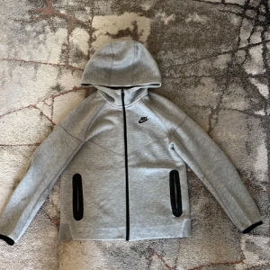 Nike tech tracksuit - Säljer en Nike tech tracksuit som är knappast använd och behöver sälja den snabbt. Storlek S. Kan gå ner i pris vid snabbaffär. Kan också byta med andra kläder.