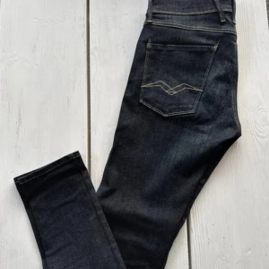 Replay Anbass mörkblå jeans - Snygga mörkblå Replay Anbass jeans med klassisk femficksdesign och kontrastsömmar. Jeansen har en slim passform och är tillverkade i stretchig denim för extra komfort. Märkesdetaljer syns på fickan och bakfickan har en unik broderad design. Priset är alltid öppen för att diskuteras skriv om ni har frågor kring något 