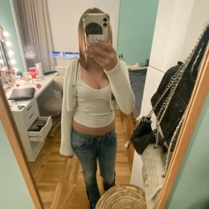 Vit croppad kofta med pärlknappar - Superfin vit croppad kofta från Lindex med ribbat stickat material och snygga pärlknappar framtill. Storlek 134/140 💕