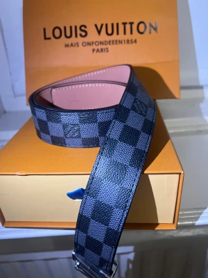Louis Vuitton bälte – äkta - Säljer ett Louis Vuitton-bälte (äkta) i Damier-mönster. Bältet är i bra skick och har endast använts vid ett fåtal tillfällen.  Äkthet: 	•	Date code finns präglad på insidan (se bild) 	•	Detaljer, sömmar och material stämmer överens med original 	•	Köpt av tidigare ägare som uppgav att bältet är äkta  Original box och dustbag medföljer.  Säljes pga kommer ej till användning. Skickas spårbart eller möts upp. Hör av dig vid frågor eller om du vill ha fler bilder. 