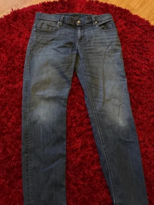 Blå raka jeans från Alberto  - Säljer ett par klassiska blå jeans från Alberto med rak passform och fem fickor. Jeansen har en snygg tvättad look och detaljer som alberto -lapp bak i midjan. Perfekta till en avslappnad stil och tillverkade i slitstarkt denimtyg.
